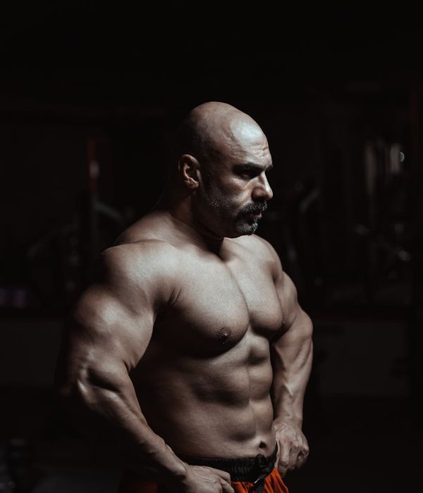 Man performing a powerful strength training exercise in a focused environment.